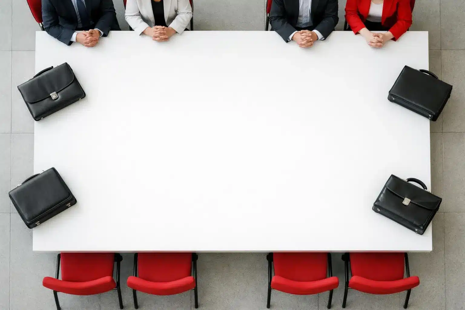 French labor union representatives and employer organization officials sitting at opposite ends of an empty negotiation table in a formal meeting room, with chairs pushed back and abandoned briefcases, symbolizing the breakdown of social dialogue and collective bargaining under Macron's policies, photographed in a somber documentary style with natural lighting highlighting the vacant space between the two groups