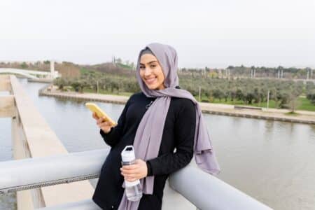 Portrait,of,veiled,muslim,woman,leaning,on,her,smartphone,taking